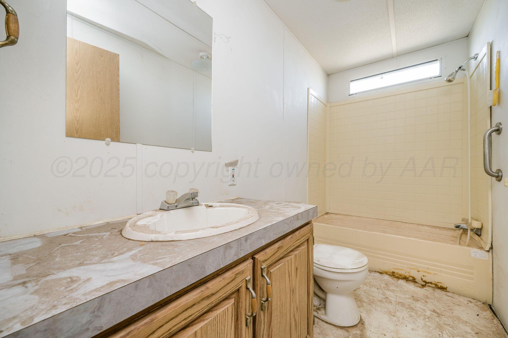 1061 Tascosa Road Amarillo, TX 79124 - Photo 18 of 31 a bathroom with a granite countertop sink toilet and shower