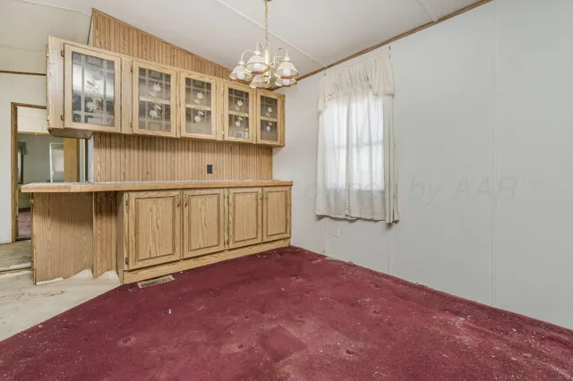 a kitchen with stainless steel appliances granite countertop a refrigerator a sink dishwasher and white cabinets with wooden floor