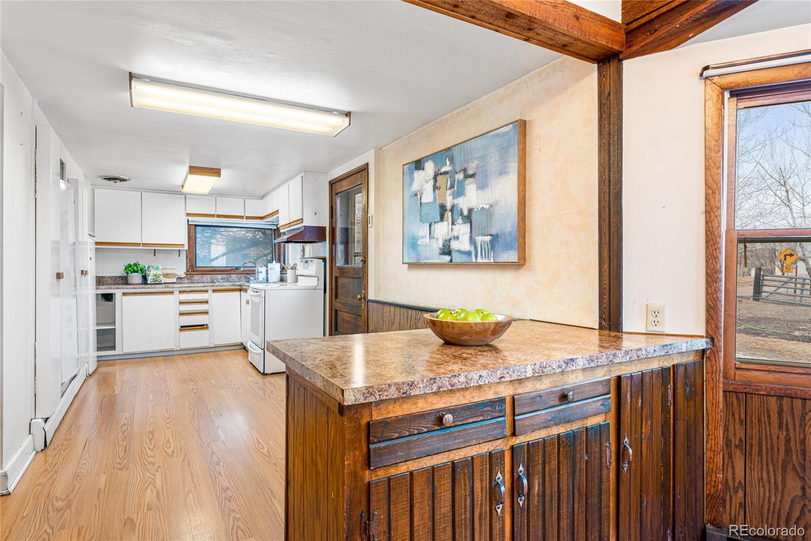 3152 Indian Road Boulder, CO 80301 - Photo 14 of 49 a kitchen with kitchen island granite countertop wooden cabinets and refrigerator