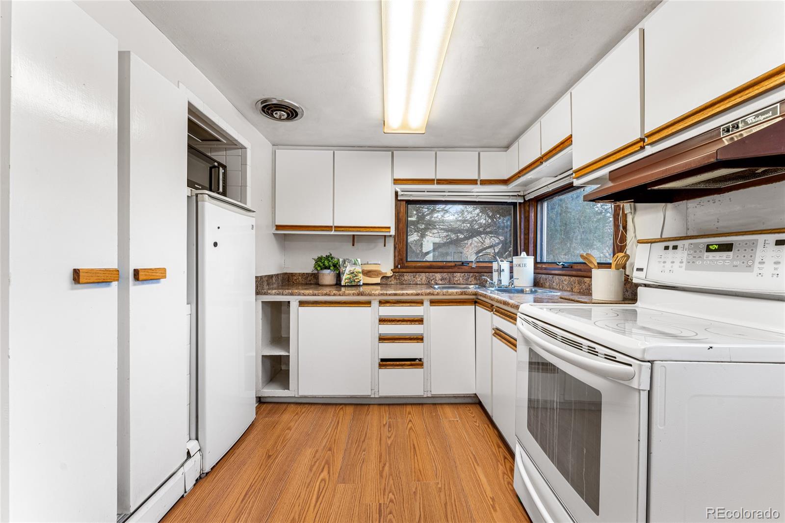 3152 Indian Road Boulder, CO 80301 - Photo 17 of 49 a kitchen with white cabinets and white appliances