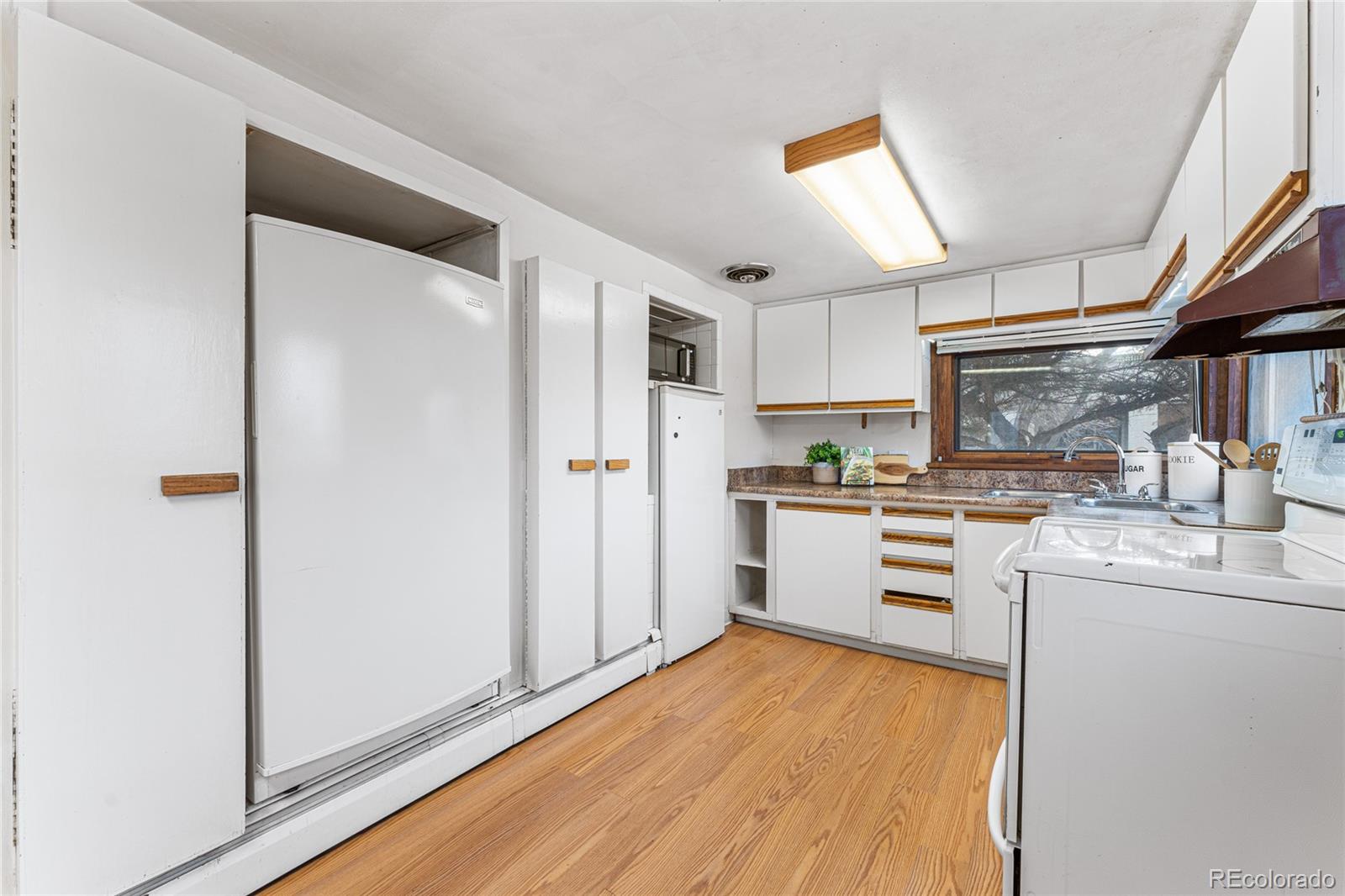 3152 Indian Road Boulder, CO 80301 - Photo 19 of 49 a kitchen with white cabinets and stainless steel appliances