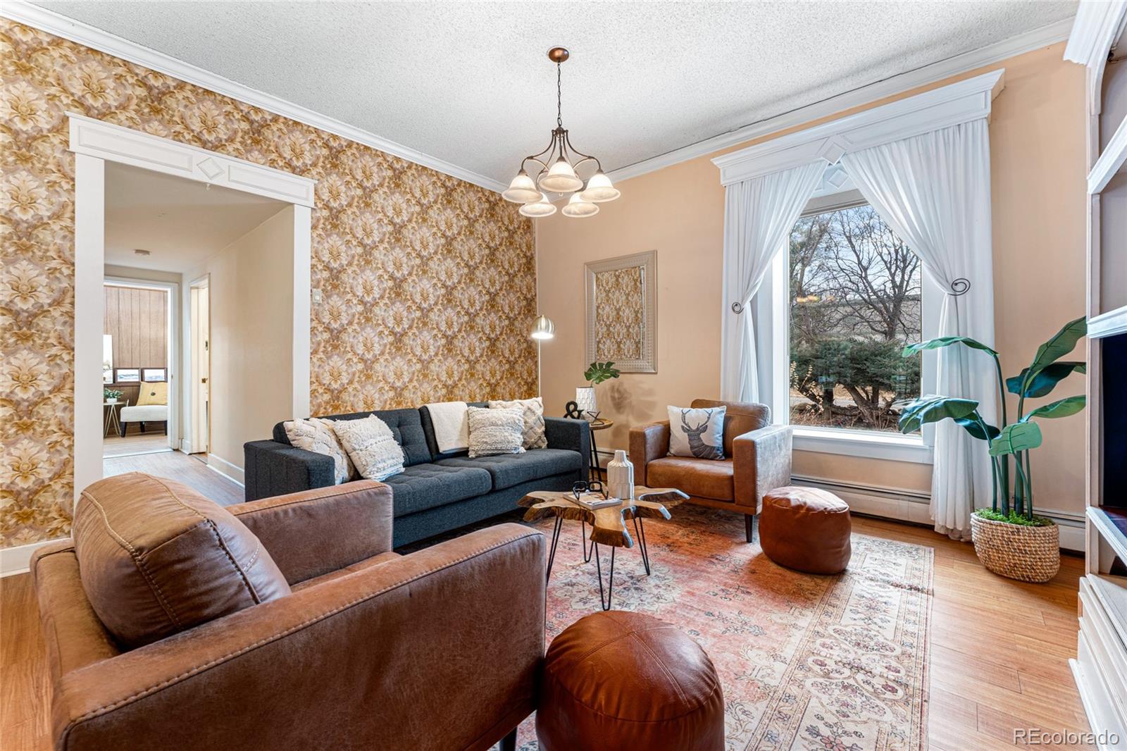 3152 Indian Road Boulder, CO 80301 - Photo 5 of 49 a living room with furniture a chandelier and a fireplace