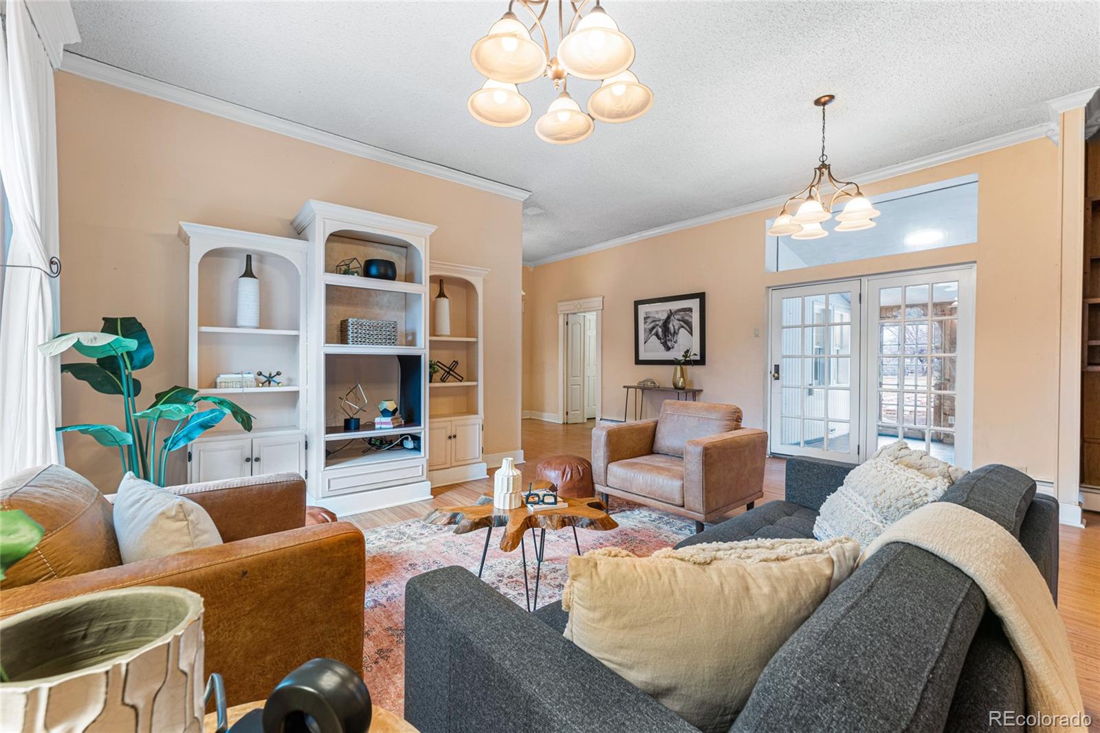 3152 Indian Road Boulder, CO 80301 - Photo 8 of 49 a living room with furniture a wooden floor and a chandelier