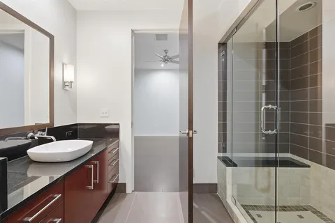 a bathroom with a sink a mirror and shower