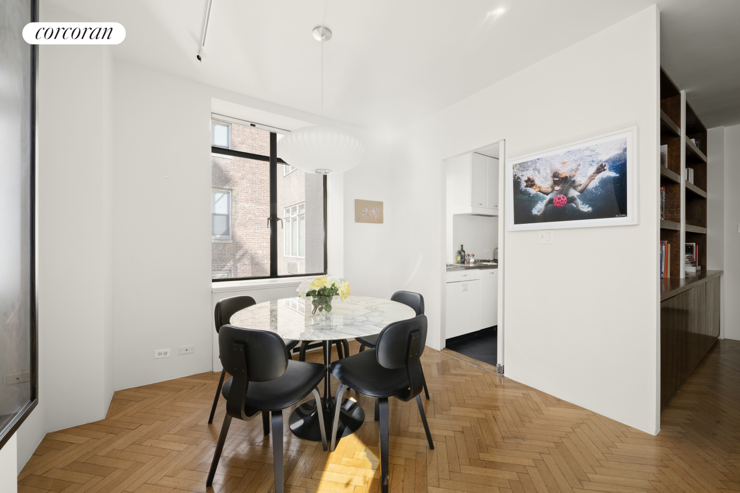 24 West 55th Street, Unit 7F Manhattan, NY 10019 - Photo 5 of 10 a view of a dining room with furniture and wooden floor