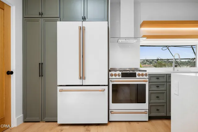 a kitchen with a refrigerator and a sink
