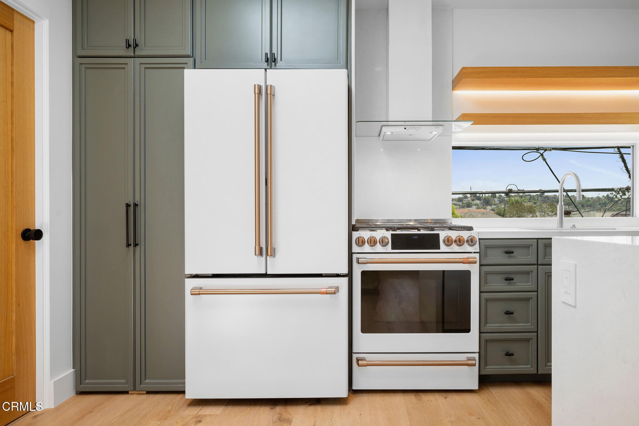 a kitchen with a refrigerator and a sink