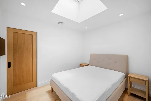 a bedroom with a bed and a cabinets