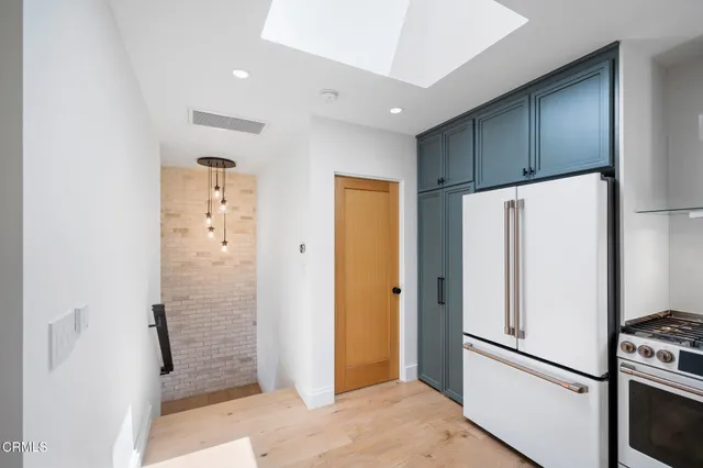 a view of a kitchen with a refrigerator and a stove