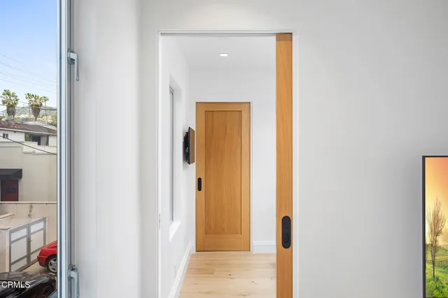 a view of a hallway with a door and front door