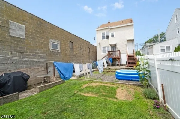 a view of a backyard with couches chairs and a fire pit