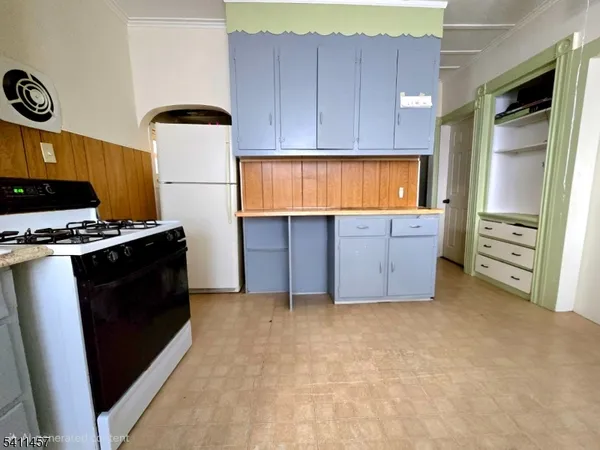 a kitchen with cabinets and a stove top oven