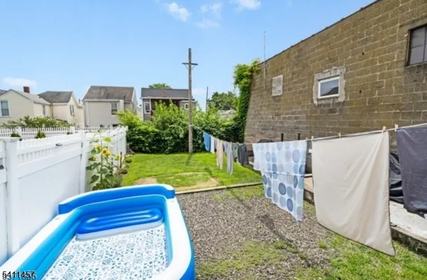 a view of a backyard with plants and outdoor seating