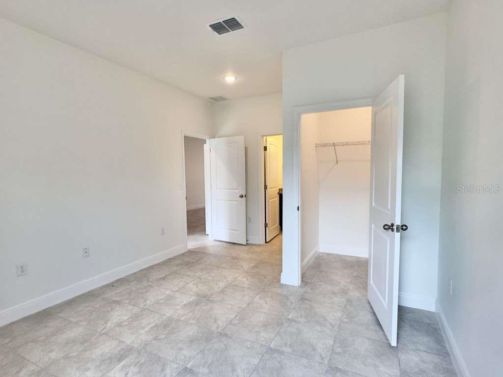 15885 Southwest 35th Court Road, Unit 1 Ocala, FL 34473 - Photo 7 of 27 an empty room with closet and a bathroom