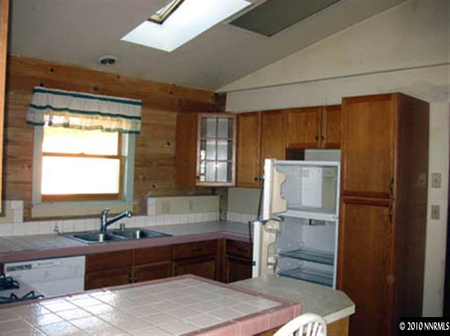 6400 Lost Springs Road Reno, NV 89510 - Photo 7 of 13 a kitchen with granite countertop a refrigerator and a sink