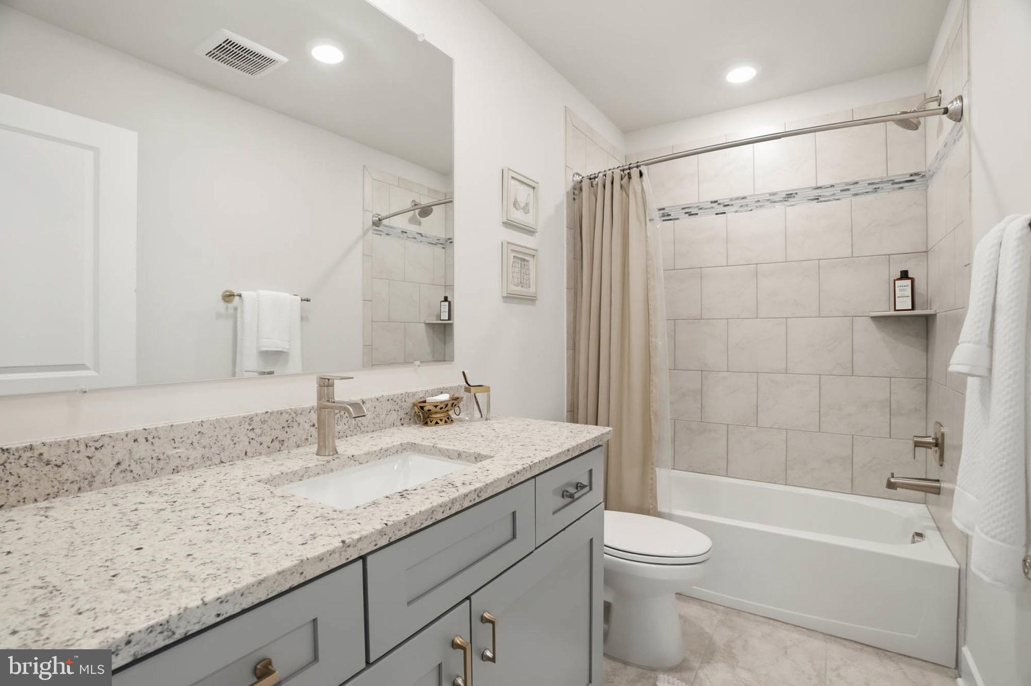 110 Bonny Way Annapolis, MD 21403 - Photo 25 of 35 a bathroom with a granite countertop sink a toilet and shower