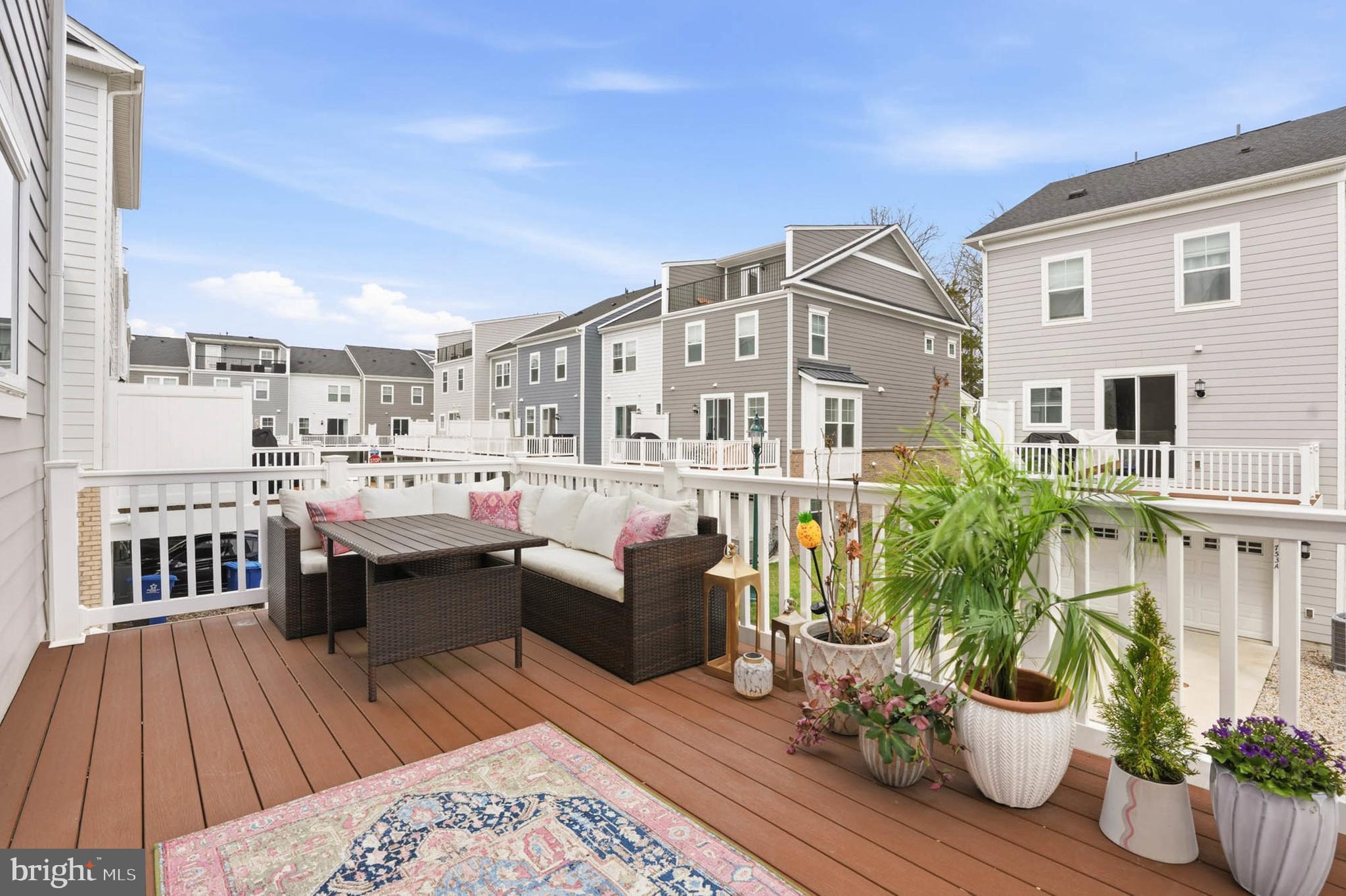 110 Bonny Way Annapolis, MD 21403 - Photo 30 of 35 a view of a patio with table and chairs potted plants with wooden floor
