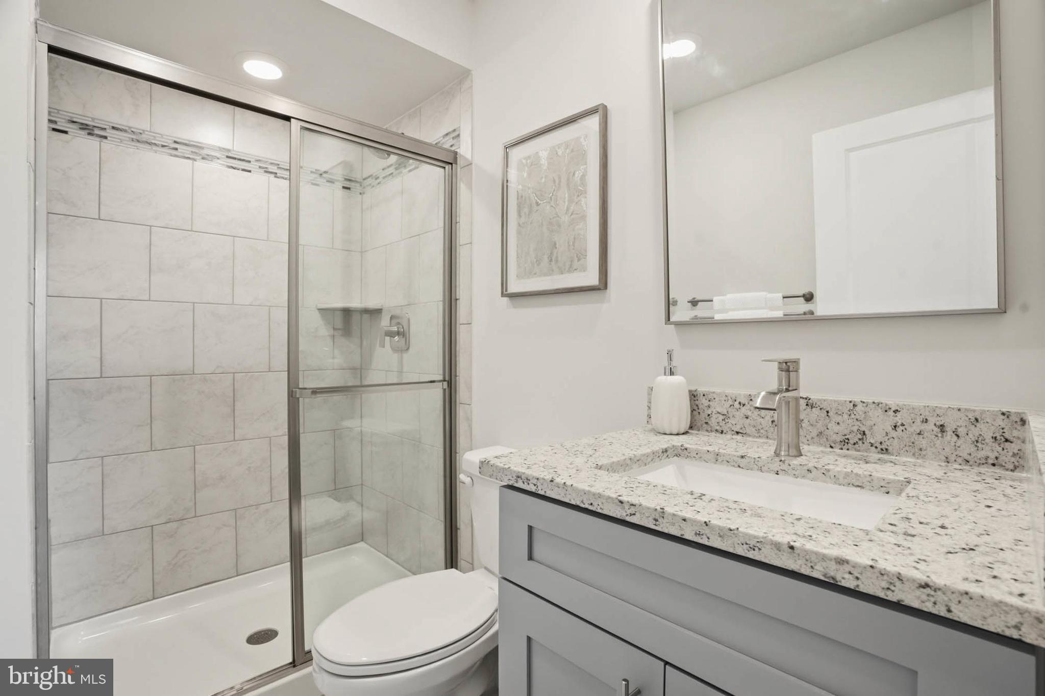 110 Bonny Way Annapolis, MD 21403 - Photo 7 of 35 a bathroom with a granite countertop sink a toilet and shower