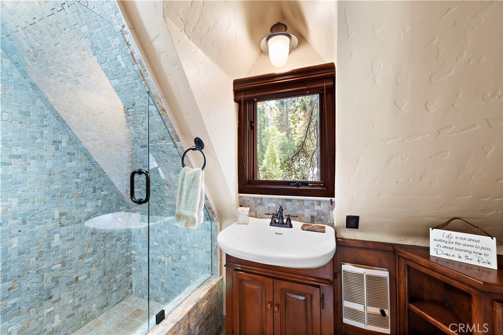 400 Cottage Grove Road Lake Arrowhead, CA 92352 - Photo 43 of 70 a bathroom with a sink a mirror and shower