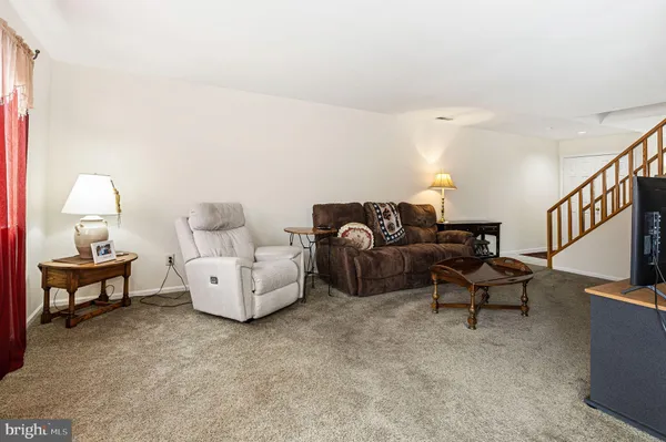 a living room with furniture and a lamp