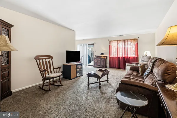 a living room with furniture and a chair