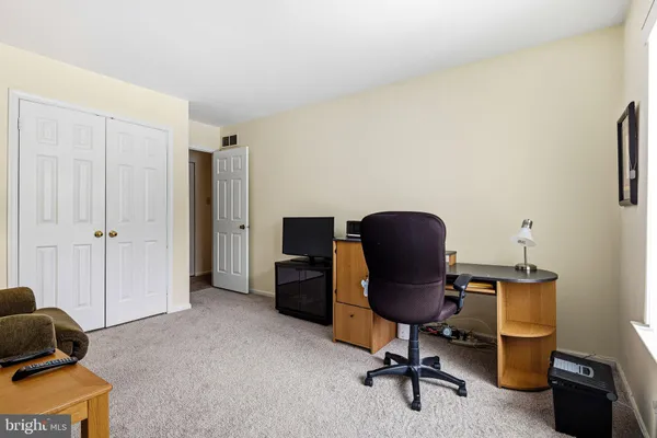 a view of a workspace with furniture