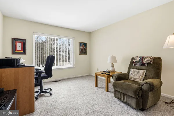 a work room with furniture and a window