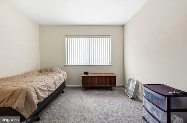 a bed sitting in a room next to a window