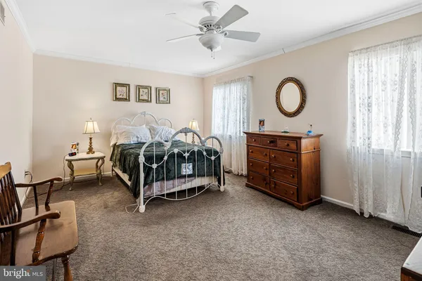 a bedroom with bed and a chandelier