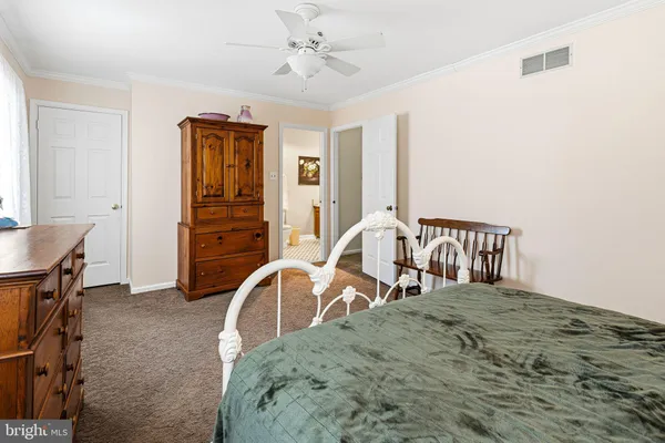 a view of a bedroom with furniture and window