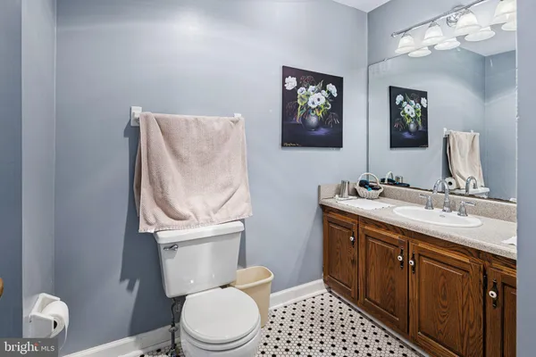 a bathroom with a toilet a sink and mirror
