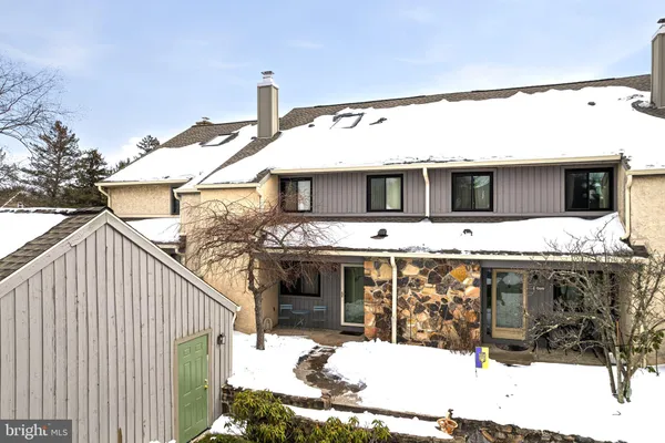 a view of a house with snow on the road