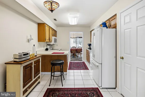 a kitchen with stainless steel appliances granite countertop a stove a refrigerator and a sink