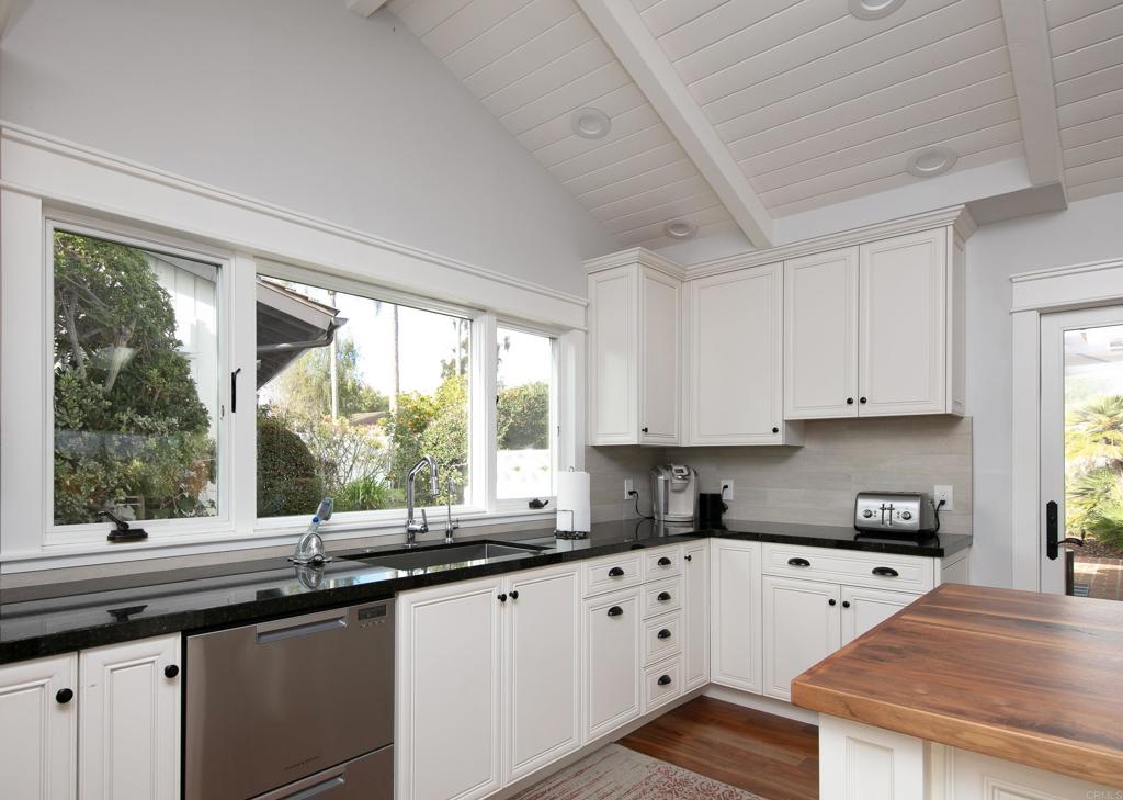 6145 La Flecha, Unit 4 Rancho Santa Fe, CA 92067 - Photo 11 of 26 a kitchen with granite countertop a stove a sink a granite counter tops and a large window