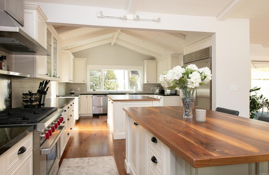 6145 La Flecha, Unit 4 Rancho Santa Fe, CA 92067 - Photo 13 of 26 a kitchen with sink refrigerator and stove