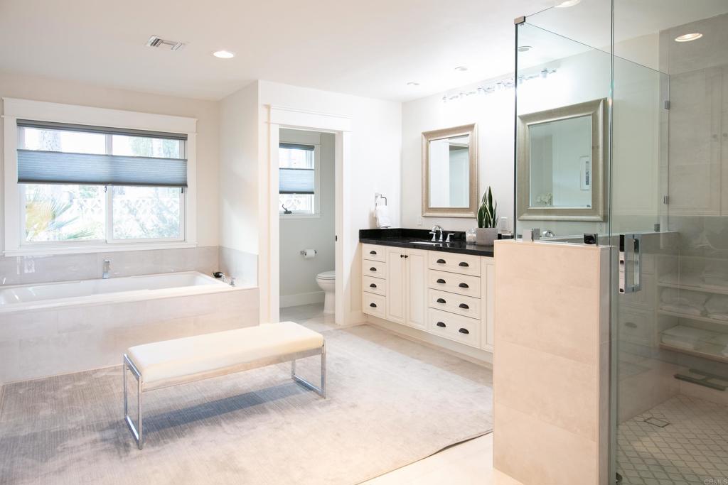 6145 La Flecha, Unit 4 Rancho Santa Fe, CA 92067 - Photo 18 of 26 a spacious bathroom with a double vanity sink a mirror and a bathtub