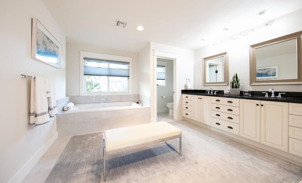 6145 La Flecha, Unit 4 Rancho Santa Fe, CA 92067 - Photo 20 of 26 a spacious bathroom with a double vanity sink a mirror and a bathtub