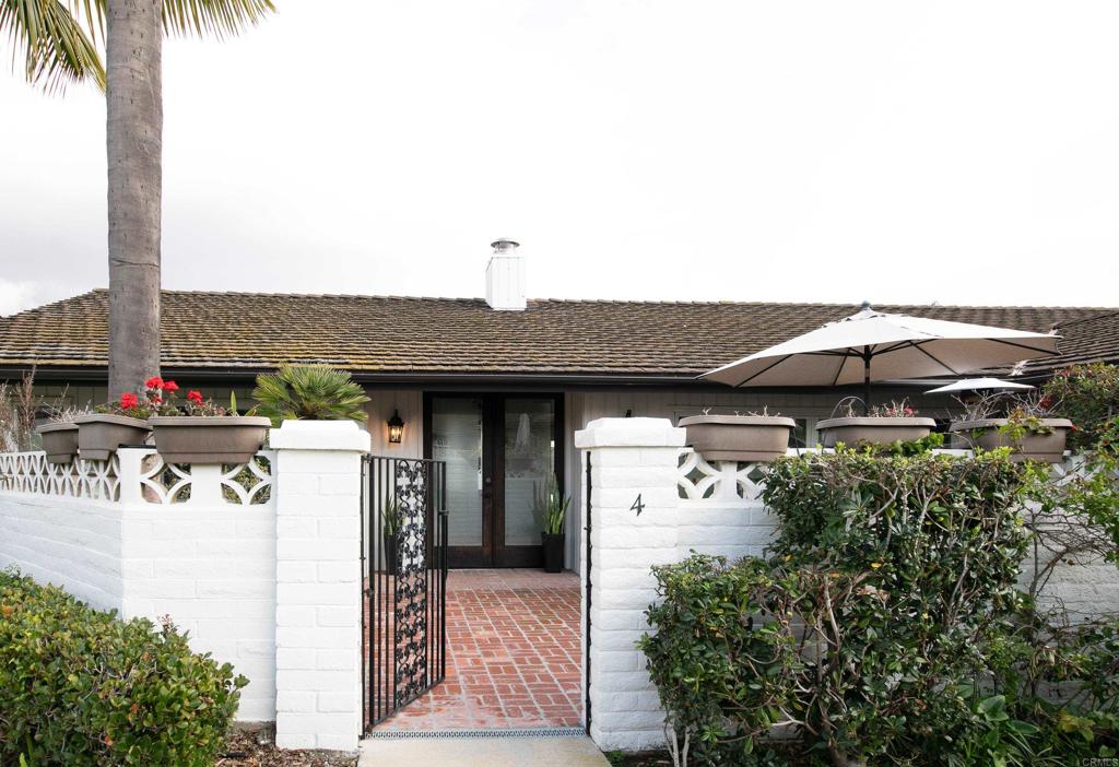 6145 La Flecha, Unit 4 Rancho Santa Fe, CA 92067 - Photo 2 of 26 a front view of a house with a yard