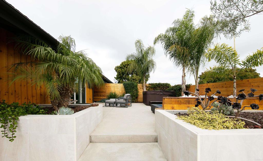 6145 La Flecha, Unit 4 Rancho Santa Fe, CA 92067 - Photo 26 of 26 a view of swimming pool with a table and chairs under palm trees