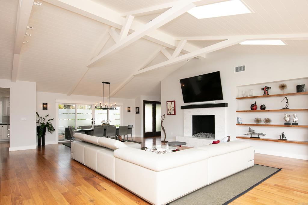6145 La Flecha, Unit 4 Rancho Santa Fe, CA 92067 - Photo 7 of 26 a living room with furniture a fireplace and a flat screen tv
