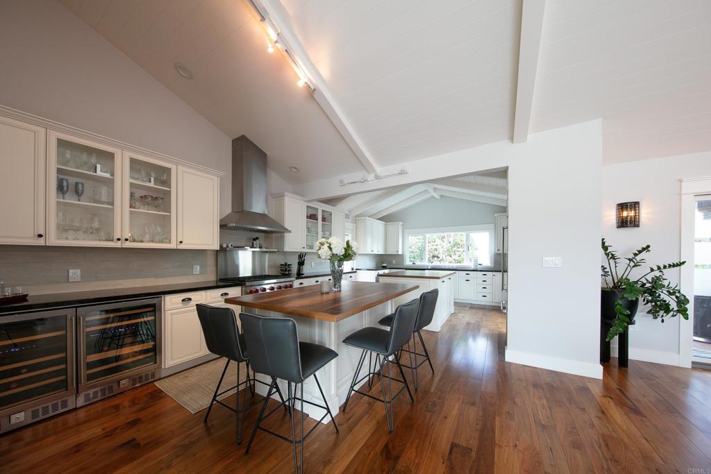 6145 La Flecha, Unit 4 Rancho Santa Fe, CA 92067 - Photo 9 of 26 a kitchen with stainless steel appliances a table and chairs in it