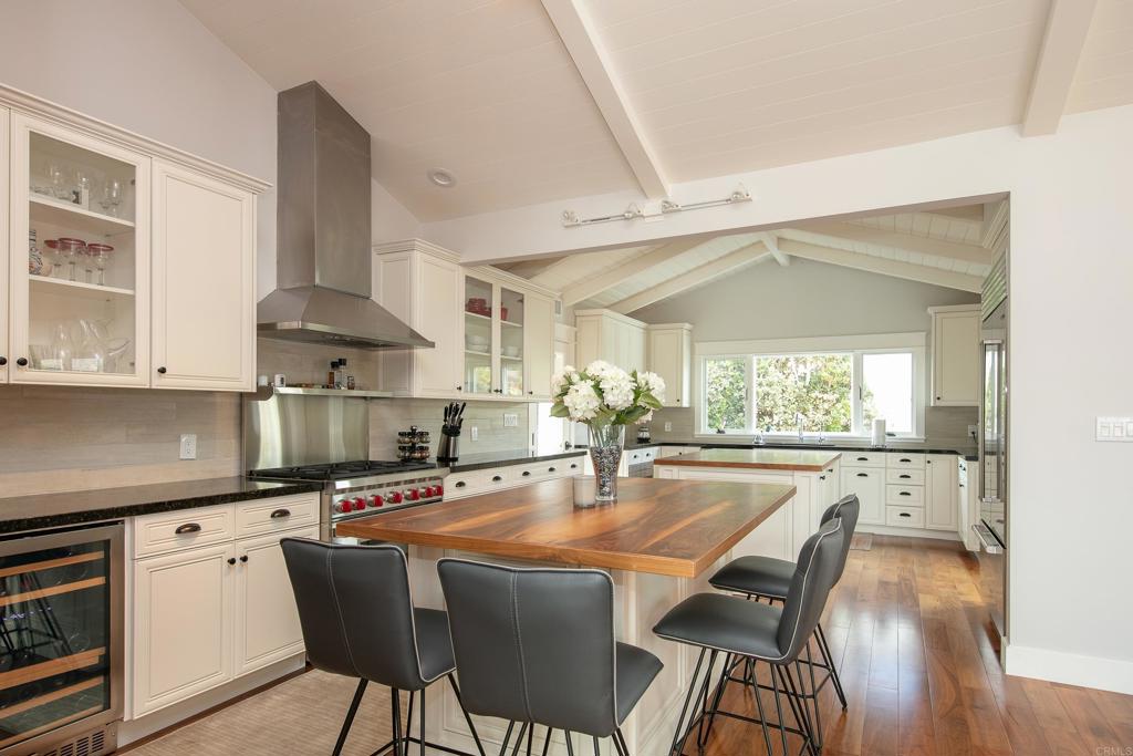 6145 La Flecha, Unit 4 Rancho Santa Fe, CA 92067 - Photo 10 of 26 a kitchen with stainless steel appliances a dining table chairs stove and cabinets