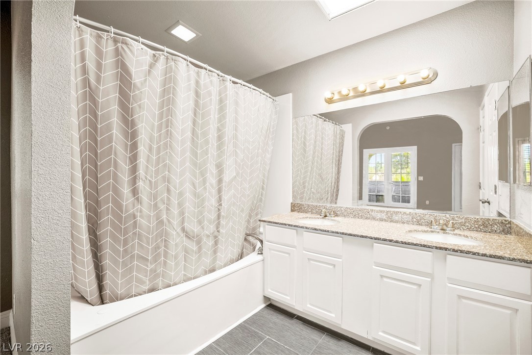 3311 Sunfish Drive, Unit D Henderson, NV 89014 - Photo 10 of 21 Double vanity and a full-size tub with shower in this functional bathing space.