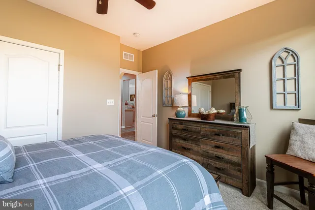 a bedroom with a bed and windows