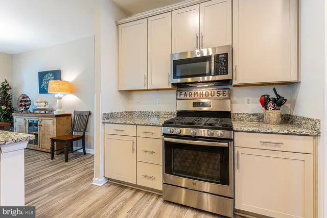 a kitchen with a refrigerator a sink and wooden cabinets