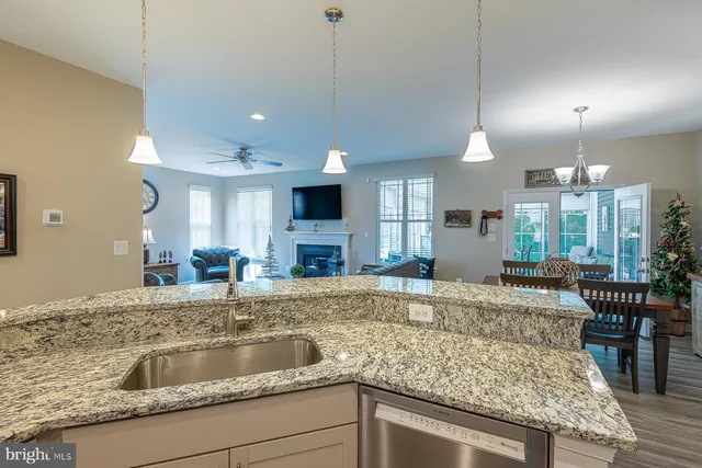 a kitchen with stainless steel appliances granite countertop a stove microwave and sink