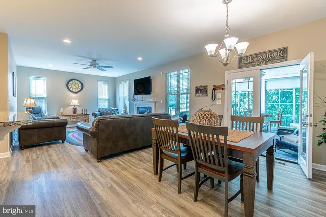 a kitchen with stainless steel appliances kitchen island granite countertop a table and chairs in it
