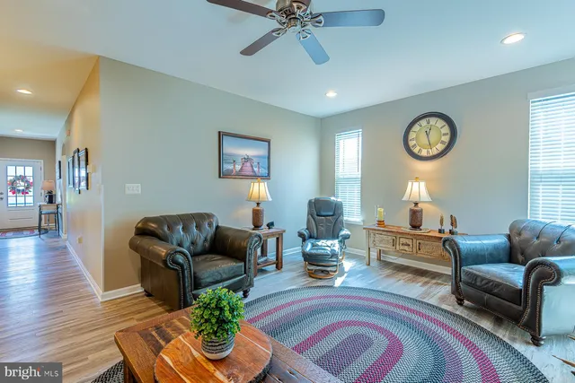a living room with furniture and kitchen view