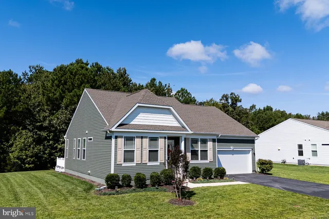a aerial view of a house next to a yard