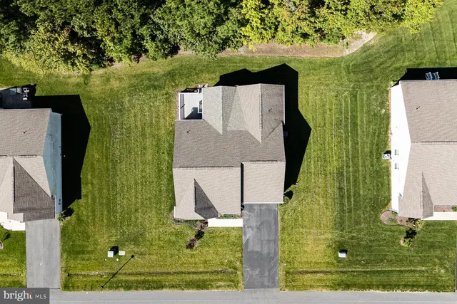 an aerial view of a house with a yard
